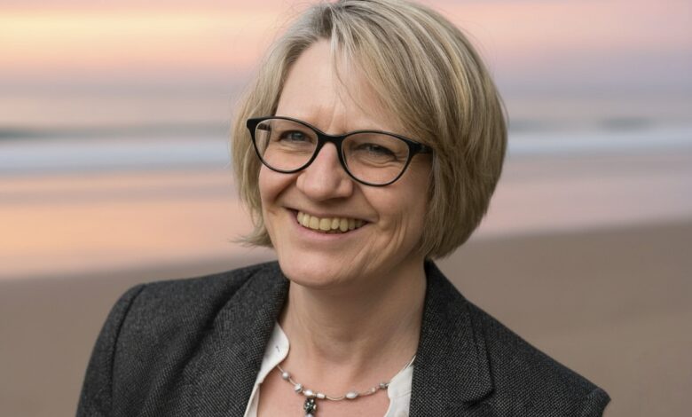 Pat Gordon Smith speaking at a community event, sharing insights with an engaged audience.”