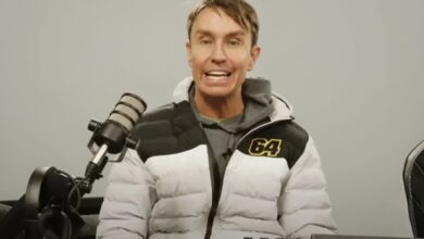 Mark McCann standing beside one of his supercars from his YouTube videos.”