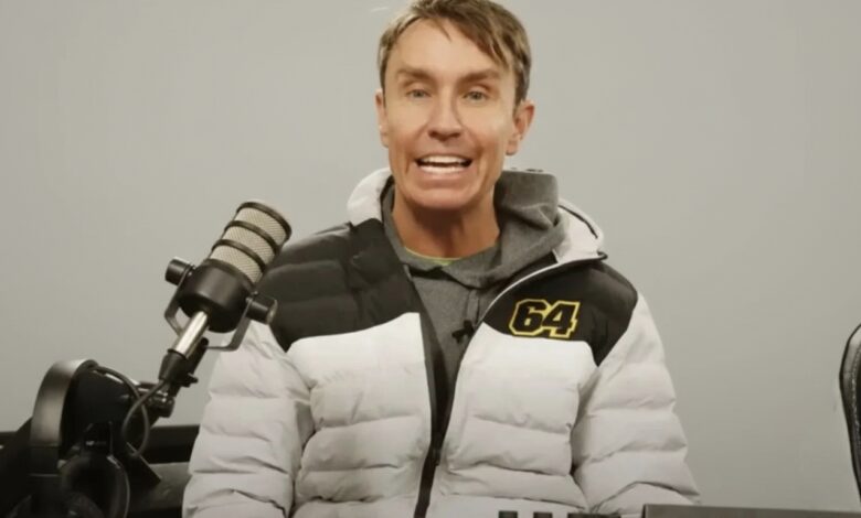 Mark McCann standing beside one of his supercars from his YouTube videos.”